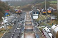 Looking south over what was once the Midland Railway mainline from Manchester to London at Peak Forest on 9 April 2012 as 66143 moves empty wagons off the mainline past Peak Forest South SB. Peak Forest station building is out of shot to the right of the photograph and is still in use as offices for DB Schenker. <br><br>[John McIntyre 09/04/2012]