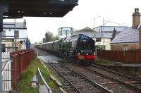 Nearing the end of the journey on Day 6 of the Railway Touring Company's <I>'Great Britain V'</I> railtour, with the weather having taken a turn for the worse. Ex-LMS Coronation Class pacific 46233 'Duchess of Sutherland' brings the 13 coach load effortlessly through Bamber Bridge at speed heading for the overnight stop at Preston.<br><br>[John McIntyre 26/04/2012]