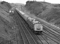 The first two months of 1977 saw the 'Western' diesel-hydraulics ranging far and wide on railtour duty as their demise drew near. Here No. 1023 'Western Fusilier' accelerates past Goose Hill Junction, Normanton, having suffered a signal check on the approach, with the <I>'Western Finale'</I> special from Exeter to York.<br><br>[Bill Jamieson 12/02/1977]