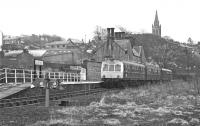 A DMU from Halwhistle stands at the Alston terminus on 27 March 1976. Two cars would normally have sufficed for the traffic to and from Alston but, so close to closure of the branch, the authorities were presumably expecting increased loadings due to enthusiasts paying their last respects.<br><br>[Bill Jamieson 27/03/1976]