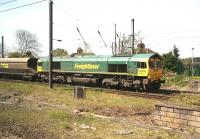 Freightliner 66557 with empty coal hoppers in Holgate sidings south of York station. Photographed from a passing train on 22 April 2012.<br><br>[John Furnevel /04/2012]