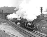 <I>Hardwicke</I> piloting <I>Flying Scotsman</I> on a train of preserved saloons running between Carnforth and Carlisle in May 1976 as part of the Settle and Carlisle centenary celebrations. The train had been booked to be worked as far as Hellifield by the Midland Compound and Black 5 No 44871, but neither proved fit on the day, resulting in this stopgap pairing, seen approaching Wennington. The trackbed of the closed ex-MR line to Lancaster Green Ayre is prominent on the left.<br><br>[Bill Jamieson 01/05/1976]