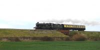 Ex-GWR 'Castle' class 4-6-0 no 5043 <I>Earl of Mount Edgcumbe</I> passing the village of Uffington, Oxfordshire, on 29 April 2012 with support coach in tow.<br><br>[Peter Todd //]