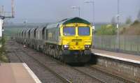 Killoch - Drax loaded coal hoppers passing New Cumnock on 26 April with Freightliner 66585 in charge.<br><br>[Ken Browne 26/04/2012]