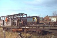 47448 does some leisurely shunting in the yard at 10D, Lostock Hall MPD, in January 1979. The shed had by this time been reduced to a wagon repair facility for the local civil engineers; hence the fire damaged Shark brake van in the foreground. Behind the Brush Type 4 runs the Farington Curve to Blackburn line. The photo was taken from what was once the scrap line for the steam locos that were withdrawn from Lostock Hall. The shed closed completely not long after this picture was taken and was later demolished, although the site has yet (2012) to be redeveloped. 47448, the former D1565, worked for a further twelve years before withdrawal from Crewe in January 1991. It was cut up at Booths, Rotherham some five years later.<br><br>[Mark Bartlett 04/01/1979]