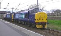 Platform scene at Ardrossan South Beach on 24 April 2012 with DRS 37194+37667 passing on the 6M22 Hunterston - Carlisle Yard nuclear flasks. [Editor's note: Locomotive 37667 (then D6851) hauled the last down Anglo-Scottish freight over the Waverley Route (the 08.30 Kingmoor-Millerhill) on Saturday 4th January 1969.]<br><br>[Ken Browne 24/04/2012]