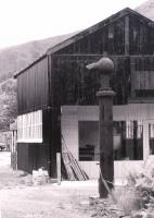 The old goods shed at Dinas Mawddy in July 1981 as modified for use as a workshop - with the remains of a water crane in the foreground.<br><br>[Colin Miller /07/1981]