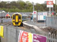 A modern-day view of Milford Haven [see image 38657 for the same view twenty six years earlier] as 158838 lays over following arrival on 18 April 2012 (before being failed with a fuel leak on the nearest carriage). The Tesco superstore and retail complex seen on the left have superceded the sidings and livestock market seen in the former image although, thankfully, the station run round line is still in place alongside the service road to the parking areas for the complex.<br><br>[David Pesterfield 18/04/2012]