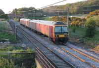 <I>Probably just a coincidence...</I> but on the day the cost of a First Class stamp rose by 30% the evening Up WCML Postal ran as a four car set (as opposed to the usual eight or twelve). EPU 325008 heads south at Woodacre near Garstang. It has just been reported that long out of use sister unit 325010 has gone to Ron Hull's at Rotherham for scrapping. <br><br>[Mark Bartlett 30/04/2012]