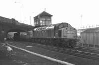 EE Type 4 No. 345 swoops under London Road and past St. Margarets box on the 11.50 Aberdeen to Kings Cross Freightliner service on 28 February 1970. Meadowbank stadium is bathed in sunshine on what had been a fine afternoon but by four o'clock or so the railway is completely in shadow and this was the last shot of the day.<br><br>[Bill Jamieson 28/02/1970]