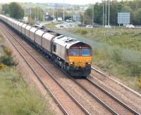 Coal empties from Longannet power station on their way back to Hunterston shortly after noon on 9 May 2012 behind EWS liveried 66015. The train has just crossed Helensfield Bridge over the A907 in the centre background [see image 12813] and is  now running parallel with the road on the eastern approach to Alloa. The track on the left is part of Alloa East loop. <br><br>[John Furnevel 09/05/2012]