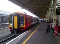 A South Western Trains 159 [see image 38394] adds a splash of colour to a greyish Bath Spa station on 7 April 2012. Notice the coffee bar on the right, where I bumped into a railtouring friend whom I had not seen for about 5 years!<br><br>[Ken Strachan 07/04/2012]