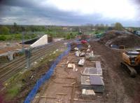 Concrete progress - literally - on the Nuneaton North Chord on 5 May 2012. The two recently completed walls on the left will support the embankment leading to the bridge over the chord from the WCML to the Birmingham line. To the right 66715 [see image 38725] is passing the North Chord turnout from the flyover line from platforms 6 and 7 to Birmingham with a train of containers.<br><br>[Ken Strachan 05/05/2012]