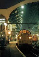 Multilingual announcements echo around Liverpool Street station as the <I>Hook Continental</I> boards on Sunday 23rd October 1977. This train ran non-stop to Harwich Parkeston Quay to connect with the evening ferry sailing to the Hook of Holland. Station tannoys down the line would soon be blaring urgent warnings to 'stand clear of the platforms as a fast through train is approaching'. Driven flat out on a top priority passenger express, Class 37s became transformed into something quite frightening... even for seasoned observers. <br><br>[Mark Dufton 23/10/1977]