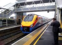 The new order at Loughborough: an up Class 222 Meridian passes below the new footbridge on 27 April 2012, under the watchful eye of a suit with a 'phone. The station refurbishment here is now complete.<br><br>[Ken Strachan 27/04/2012]