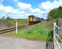 The 12.59 Preston to Ormskirk service approaches Pages level crossing, just south of Midge Hall, on 12 May 2012. Single car unit 153330 forms the train.<br><br>[John McIntyre 12/05/2012]