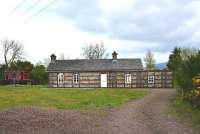 The former Creetown Station is now a private dwelling, seen here in May 2012. The owner has kept the old station's origins alive with the brake van close by. [See image 38855]<br><br>[John Gray /05/2012]