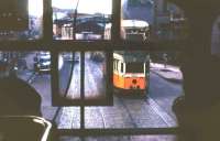 One Glasgow 'Coronation' tram glimpsed from another on 4th August 1962, a month before the system was finally closed down. By this time only route 9 remained operational, between Dalmuir and Auchenshuggle, basically running on an east/west axis through the city centre. The scene is on London Road, between Bridgeton Cross and Fielden Street, in an area that has changed beyond all recognition since the photograph was taken.<br><br>[Frank Spaven Collection (Courtesy David Spaven) 04/08/1962]