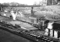 EE Type 4 No. D253 makes the Berwick call on 9 March 1968 with the early morning York to Edinburgh train. The steam heating boiler is clearly functioning properly although the state of the hose connections is questionable. In the background a United Automobile Services vehicle, which I think is a Bristol LS5G, heads north on the A1.<br><br>[Bill Jamieson 09/03/1968]