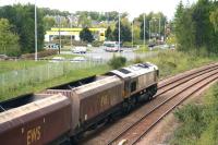 The approach to Alloa from the east on 9 May 2012, with Clackmannan Road roundabout in the background. EWS liveried 66015 is passing with coal empties from Longannet power station heading for Hunterston. The track on the right is part of Alloa East loop. <br><br>[John Furnevel 09/05/2012]