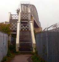 Something old (the steps), something new (the replacement deck), something borrowed (that bush certainly shouldn't be sticking out of the steps), and something distinctly not blue - the weeping sky was rather grey. Unusual to see a new deck and old steps; the bridge is on the West side of the station.<br><br>[Ken Strachan 25/04/2012]