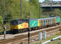 Colas Rail 47739 hauls Merseyrail emu 507012, sandwiched between two Arlington Fleet Services barrier vehicles, on the 5Z08 move to Kilmarnock from Birkenhead on 16 May. The train is seen heading north on the WCML near Farington Junction. For a similar stock move, a little further south, almost 31 years earlier, [See image 19617]<br><br>[John McIntyre 16/05/2012]