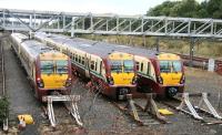 A trio of class 334 emus lined up in the sidings at Yoker Depot, Glasgow, on a wet Sunday morning in September 2007.<br><br>[John Furnevel /09/2007]