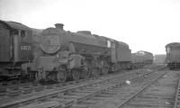 Leeds Holbeck Black 5 no 45079 stands in the shed yard at Gateshead in October 1964 alongside 52A's A3 Pacific no 60071 <I>'Tranquil'</I>. View is east towards Greensfield with the original Chaytor's Bank roundhouse visible in the right background.<br><br>[K A Gray 24/10/1964]