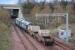 DRS 57011 and 57002 leave Millerhill with the Torness - Sellafield flask train on 10 April 2012. On the left is the start of the Borders Railway.<br><br>[Bill Roberton 10/04/2012]