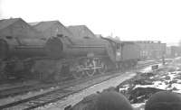 A chilly looking Darlington shed plays host to Gresley V2 2-6-2 no 60847 <i>'St Peter's School, York, AD 627'</i> on a snowy day in the early 1960s. The locomotive was eventually withdrawn from York shed in June 1965. <br><br>[K A Gray //]