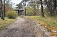 The surviving Speyside platform at Craigellachie in May 2012 looking north west towards the A95 road bridge. The line curved south towards Boat of Garten beyond the bridge. Behind the camera the route continued to Keith. The Elgin platforms stood off to the right beyond the trees. Craigellachie closed to passengers in May 1968. For a view looking back over the station from the road bridge half a century earlier [see image 22477].<br><br>[John Furnevel 20/05/2012]