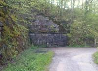 This blocked-up tunnel mouth (east portal, looking west towards Keswick Town) explains why the path is so steep on either side. There is a wooden walkway around the hill to the right - a slightly heart-in-mouth trip on a bike, in the wet!<br><br>[Ken Strachan 14/05/2012]