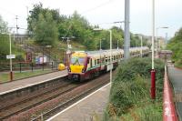 The 11.42 Milngavie - Lanark service calls at Airbles (opened 1989) on an August afternoon in 2006. The station name sign here is claimed by some to hold a record [see image 30440].   <br><br>[John Furnevel 14/08/2006]