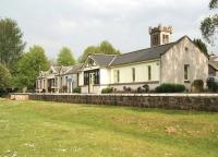 The beautifully preserved station building at Aberlour, photographed on 24 May 2012. View is east with the River Spey behind the camera. The neo-Norman tower of Aberlour Parish Church stands in the background. <br><br>[John Furnevel 24/05/2012]