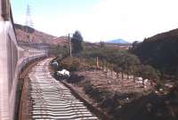 Putting the second track back 11 years after it was lifted - a southbound Highland Main Line train passes a continuous corridor of new concrete sleepers between Dalnaspidal and Blair Athol in 1977.<br><br>[Frank Spaven Collection (Courtesy David Spaven) //1977]