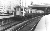 A Class 421 (4-CIG) emu waiting to leave Waterloo in 1981 with other commuter stock stabled in the west sidings in the background. This section of the station would change beyond recognition just over 10 years later when the International terminus for the new Eurostar services was built here. These would be handled at Waterloo from 1994 until finally being moved to the transformed St Pancras station in 2007. [See image 37187]<br><br>[John Furnevel 17/09/1981]