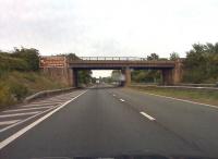 The unusual 'twin' road and rail bridge over the M50, which was demolished in March 2012 [see image 38067], seen from the Welsh side some two years earlier. So Malvern is to the left, Tewkesbury to the right, and this is the 'road side' of the bridge. But it was symmetrical, so you would see a similar view from the 'rail side' if you were driving towards Wales. Updated 2016: at least some of these spans were transported to Hosted Keynes to allow reinstatement of Sheriff Mill viaduct, which would allow re-connection of Ardingly to the Bluebell Railway. If this project succeeds, it will be the only instance I know of, where a steam railway has replaced a masonry viaduct with a steel bridge.<br><br>[Ken Strachan 31/05/2010]