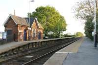 An evening view of Swinderby in Lincolnshire, looking towards Newark. The oil tank train I had just missed is disappearing southwards but the starter signal is still 'off'. <br><br>[Mark Bartlett 22/05/2012]