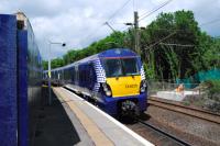 Works are underway at Hyndland to provide a new eastbound platform and relay the lines to allow bi-directional working at the present eastbound platform. This view faces west with an eastbound service entering the west end of the station. <br><br>[Ewan Crawford 12/06/2012]