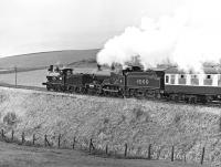 LNWR Precedent class 2-4-0 No. 790 'Hardwicke' and the Midland Compound No. 1000 head towards Clapham with the Gainsborough Model Railway Society special of 24th April 1976. Although sunny the day was rather hazy so that the fine Dales scenery in the background is barely visible.<br><br>[Bill Jamieson 24/04/1976]