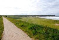 The trackbed of the Moray Coast line curves away towards Portnockie, just west of Cullen's longest viaduct. Stunning scenery on a beautiful June evening in 2012. The pretty and quirky Cullen golf club lies 80ft plus below the towering embankment. All that's missing is a railway! [See image 30341]<br><br>[Brian Taylor 12/06/2012]