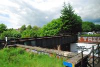 This disused single track bridge is just to the west of the main bridge over Clarence Drive just south of Hyndland station. The former purpose of this bridge was for the Caledonian Railway trains to approach Partick Goods (CR) via a reversing spur parallel to the west side of line at Hyndland approached from the east side of Crow Road station. This goods depot predated the Lanarkshire and Dumbartonshire Railway, the Caley having running powers over the Stobcross line. The Caley depot is now a housing estate whereas the former NB depot is now Partick Shopping Centre.<br><br>[Ewan Crawford 12/06/2012]