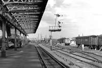 This peaceful evening scene at Wakefield Kirkgate belies the fact that there was still plenty of freight traffic through the station in 1977, and obviously still a healthy parcels traffic as testified by the many BRUTES on the platform. The view is looking east-northeast towards Normanton; the tracks curving round in the centre of the picture are from Calder Bridge Junction. For the same scene 34 years later [see image 34147]. <br>
<br><br>[Bill Jamieson /05/1977]