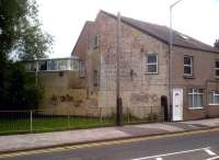 Twigs department: if you go looking for the Stockingford Brickworks branch, you may think that this diagonal house wall (complete with a painted advertisement for distemper) and substantial gateposts are Big Clues. Yes, but they aren't on the 'main branch', which was below road level behind the photographer. The gate was on a 'waste line', which ended across Croft Road in a reverse question mark shape, now followed by Leaward Close. It is overgrown with trees now, but there's quite a bit of ballast on the trackbed - now that's a clue. Update August 2015: the advertisement for distemper has now been painted over.<br><br>[Ken Strachan 09/06/2012]