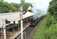 With electrification now approved this might be the last steam excursion to Blackpool to run under semaphores and without overhead wires. On 16th June 2012, 46233 slows through Poulton station for the 20 mph junction before the last leg of its run to Blackpool North.<br><br>[Mark Bartlett 16/06/2012]