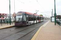 <I>Its started already</I>. Although not all the Bombardier <I>Flexitys</I> are yet in service in Blackpool one has already had advertising vinyls applied over the smart purple and white livery. Its no doubt necessary income, and its not as garish as some recent schemes [see image 24060], but we'll probably not see a plain liveried fleet again. 011 pauses at Cleveleys on its way to Fleetwood on a very wet Saturday in June 2012.<br><br>[Mark Bartlett 16/06/2012]