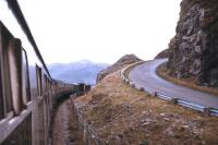 A train for Inverness heads up the coast by Loch Carron in summer 1974. The new section of the A890 shown led to rock falls and subsequent construction of the avalanche shelter over the railway - as well as some twisting re-alignments of the rail route further out from the rock face.<br><br>[David Spaven //1974]