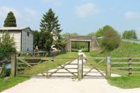 The last leg of the HIgh Peak and Tissington Trails runs north from the old station site at Hurdlow towards Buxton, as seen here from the foot of the station approach on a very sunny May morning. Even more remote than the other stations on the line Hurdlow closed in 1949, five years before the withdrawal of Buxton to Ashbourne passenger services. No trace of the station remains but a pub at the top of the approach road makes a good watering hole on days like this. <br><br>[Mark Bartlett 24/05/2012]