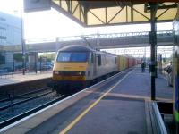 You don't often see freight at MKC in the morning. But withdrawal of my usual bus service has given me more time on the platforms awaiting an alternative. So here is 90044 heading North with boxes (GB) or cans (US) at about 7.30 on 25 May, while Southbound commuters wait for the next up service.<br><br>[Ken Strachan 25/05/2012]