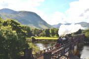 Following a major overhaul at Carnforth, K1 No.62005 is back hauling <I>'The Jacobite'</I> and is pictured crossing the viaduct over the River Lochy heading for Mallaig in June 2012. The remains of Inverlochy Castle stand in the background with Ben Nevis beyond.<br><br>[John Gray /06/2012]